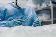 © Alberto Ortega/ADDICTIVE STOCK - Crop anonymous male veterinarian in uniform and respiratory mask using medical instruments during surgery in hospital