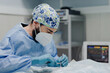 © Alberto Ortega/ADDICTIVE STOCK - Focused male veterinarian in uniform and respiratory mask using medical instruments during surgery in hospital