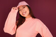 © Victor Torres/ADDICTIVE STOCK - Portrait of happy young asian woman in the studio wearing pink clothes over garnet background