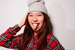 © Victor Torres/ADDICTIVE STOCK - Close-up portrait of cheerful Asian young woman sticking out tongue and looking at camera
