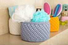 Handmade Gray Basket With Multi-colored Washcloths In The Bathroom. Hygiene And Healthy Lifestyle Concept. Decorative Element In The Interior
