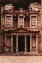 Exterior Aged Historic Al Khazneh Temple With Ornamental Details And Columns Carved Out Of Rock Located In Petra