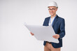 Cheerful middle-aged white engineer looking at architectural plan isolated over white background