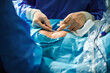© Gabriel Trujillo/ADDICTIVE STOCK - Crop unrecognizable surgeon attaching adhesive bandage on postoperative suture on breast of anonymous female patient after breast augmentation