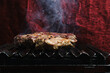 © Fatima Guisado/ADDICTIVE STOCK - Pieces of raw beef meat preparing on hot metal grill in kitchen of restaurant