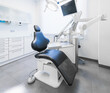 © Ioritz Lopez/ADDICTIVE STOCK - Interior of tidy light dental clinic with blue chair and modern drill apparatus
