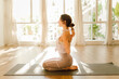 © Gerard Moral/ADDICTIVE STOCK - Side view of young dreamy female in sportswear practicing yoga with arms behind back while sitting with closed eyes in sunlight