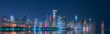 Night Cityscape Of Chicago With Contemporary Buildings And Towers Illuminated By Colorful Lights Reflecting In Calm Lake Water