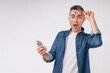 Shocked mature caucasian man using smart phone isolated over white background
