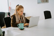 © Jake Jakab/ADDICTIVE STOCK - Blonde business woman working in front of computer in an office