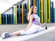 © Jose Carlos Cerdeno/ADDICTIVE STOCK - Full length delighted young flexible female wearing casual clothes performing split on street border against modern building and looking away with cheerful smile