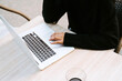 © Jake Jakab/ADDICTIVE STOCK - Ethnic woman in black sweater working on netbook at table of sidewalk cafe and typing