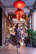 © Juan Alberto Ruiz/ADDICTIVE STOCK - Young Asian female in long dress walking along historic Daxi Old Street and looking away while enjoying vacation in Taiwan