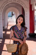 © Juan Alberto Ruiz/ADDICTIVE STOCK - Delighted Asian female traveler standing in arched passage of Cikang Overpass bridge and looking at camera while enjoying sightseeing during summer vacation in Taiwan