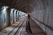 © Juan Alberto Ruiz/ADDICTIVE STOCK - Side view of Asian female in maxi dress standing in Old Baiji Tunnel in Taiwan and looking at camera