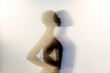 © Luis Manuel Munoz/ADDICTIVE STOCK - Double exposure of slim black female with short hair holding hands on waist against gray background