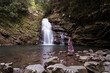 © Juan Alberto Ruiz/ADDICTIVE STOCK - Side view of female tourist standing on rock near Tiemu Falls in forest in Taiwan