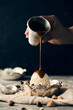 © Luis Garcia/ADDICTIVE STOCK - Unrecognizable crop person pouring sweet caramel topping on vanilla ice cream scoop in bowl placed on table with scattered nuts