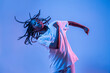 © Manuel Ruiz/ADDICTIVE STOCK - Dynamic African American teenage girl making movement while performing urban dance in neon light against blue background