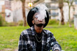© Luis Manuel Munoz/ADDICTIVE STOCK - Serious African American male wearing stylish checkered shirt sunglasses and hat smoking cigarette