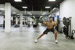 © Marina Gallardo/ADDICTIVE STOCK - Full body of strong young muscular male athlete in activewear lifting barbells during intense workout in modern gym