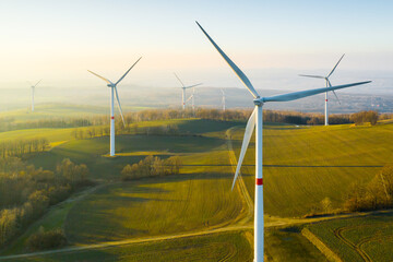 panoramic view of wind farm or wind park, with high wind turbines for generation electricity with co