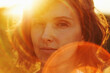 © Marianna Jaszczuk/ADDICTIVE STOCK - Crop thoughtful adult female resting in nature and looking at camera pensively under bright sunlight during golden hour