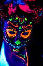 Anonymous Female In Multicolored Masquerade Mask With Flowers On Head Looking At Camera On Halloween Night