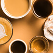 © Ramon Lopez/ADDICTIVE STOCK - Set of different classic kinds of aromatic coffee drinks served in cups of various sizes arranged on beige surface