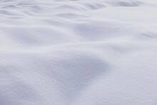 Textured Backdrop Of Snowy Terrain With White Bumpy Surface In Winter Season In Daylight