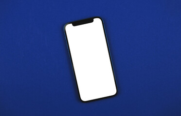 mobile phone blank screen mockup, isolated blue background, office desktop and copy space