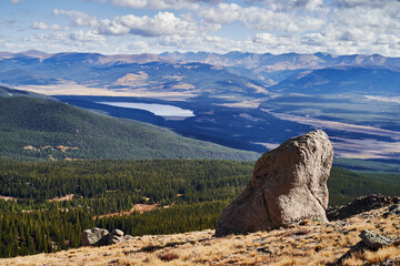 Colorado in fall. A rock in front of a distant lake near Halfmoon Creek in the Mount Massive Wilderness Area. 