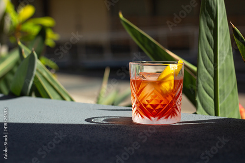 Negroni Cocktail Photo taken outside near garden in bar with room to add text. Great on it\'s own, for social media or for a poster. (landscape)
