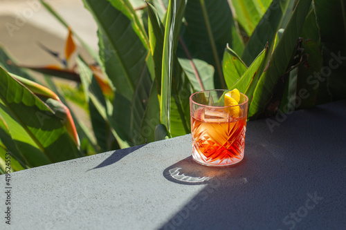 Negroni Cocktail Photo taken outside near beautiful garden in bar. Great on it\'s own, for social media or for a poster. (landscape)