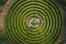 Aerial View Of A Circular Garden Maze And Green Pavilion
