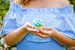 © Elena  - A plump girl in a spring blooming park holds a cupcake in her hands. Plus-size girl and sweet.