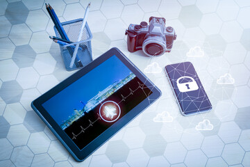 The mobile phone on the screen has a padlock and a crown network. On the table, place the camera. Tablet with aircraft symbol and port display