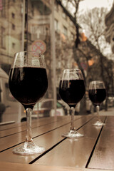 Cups with wine against a street landscape