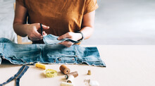 Woman Repairs Sews Reuses Fabric From Old Denim Clothes Economical Reuse