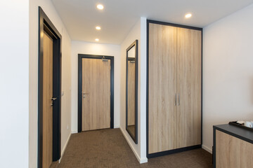 Hotel room entrance corridor with wooden closet