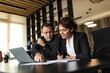 © bnenin - Two business people working in the office, portrait.