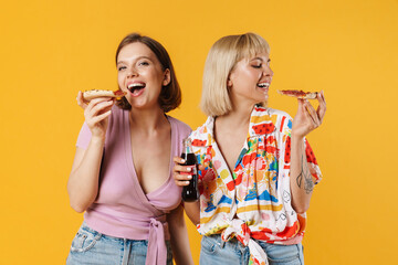 Portrait of two cheerful lovely girlfriends standing