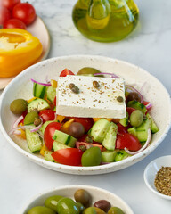 Wall Mural - Greek village salad horiatiki with feta cheese and vegetables, vegeterian mediterranean food, low calories keto dieting meal, side view, close up