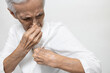 Armpit smelly or the body odor foul,Asian senior woman holding breath with fingers on nose,old elderly sniffing her wet armpit,smelling stinky,sweat from hot weather on a sunny day,bad smell problem