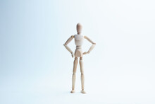 Wooden Mannequin In Different Poses On A White Background