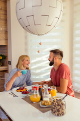 Canvas Print - Couple spending weekend morning at home, having breakfast together