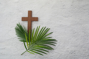 Wall Mural - Palm sunday background. Cross and palm on grey background.