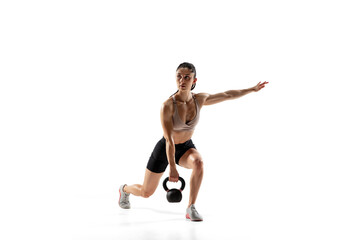 Squats with weight. Caucasian professional female athlete training isolated on white studio background. Muscular, sportive woman. Concept of action, motion, youth, healthy lifestyle. Copyspace for ad.