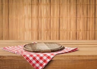 Wall Mural - Wooden cutting board and tablecloth on wooden table