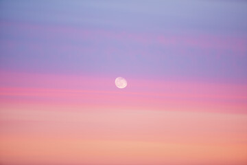 Wall Mural - beautiful backdrop of sunset sky of pink orange lilac colors and moon in center. colorful smooth daw